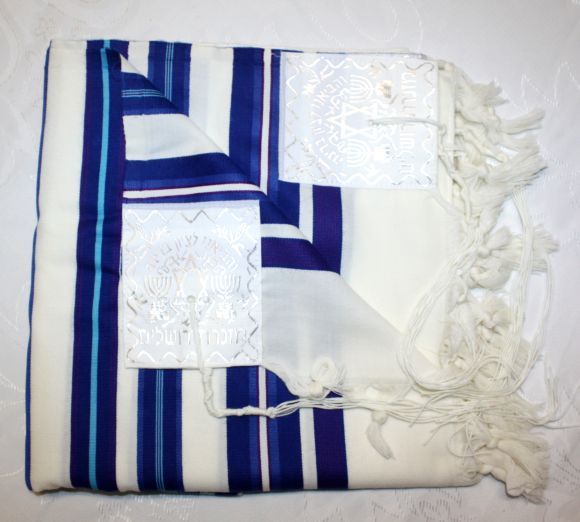 Before putting on a tallit, it is a customary tradition to kiss it and 